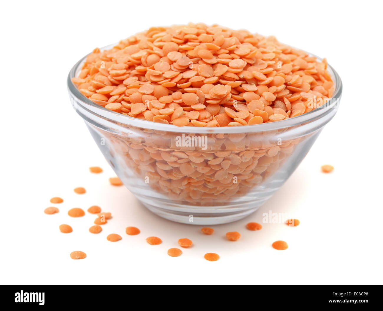 Glass bowl of peeled red lentils isolated on white Stock Photo