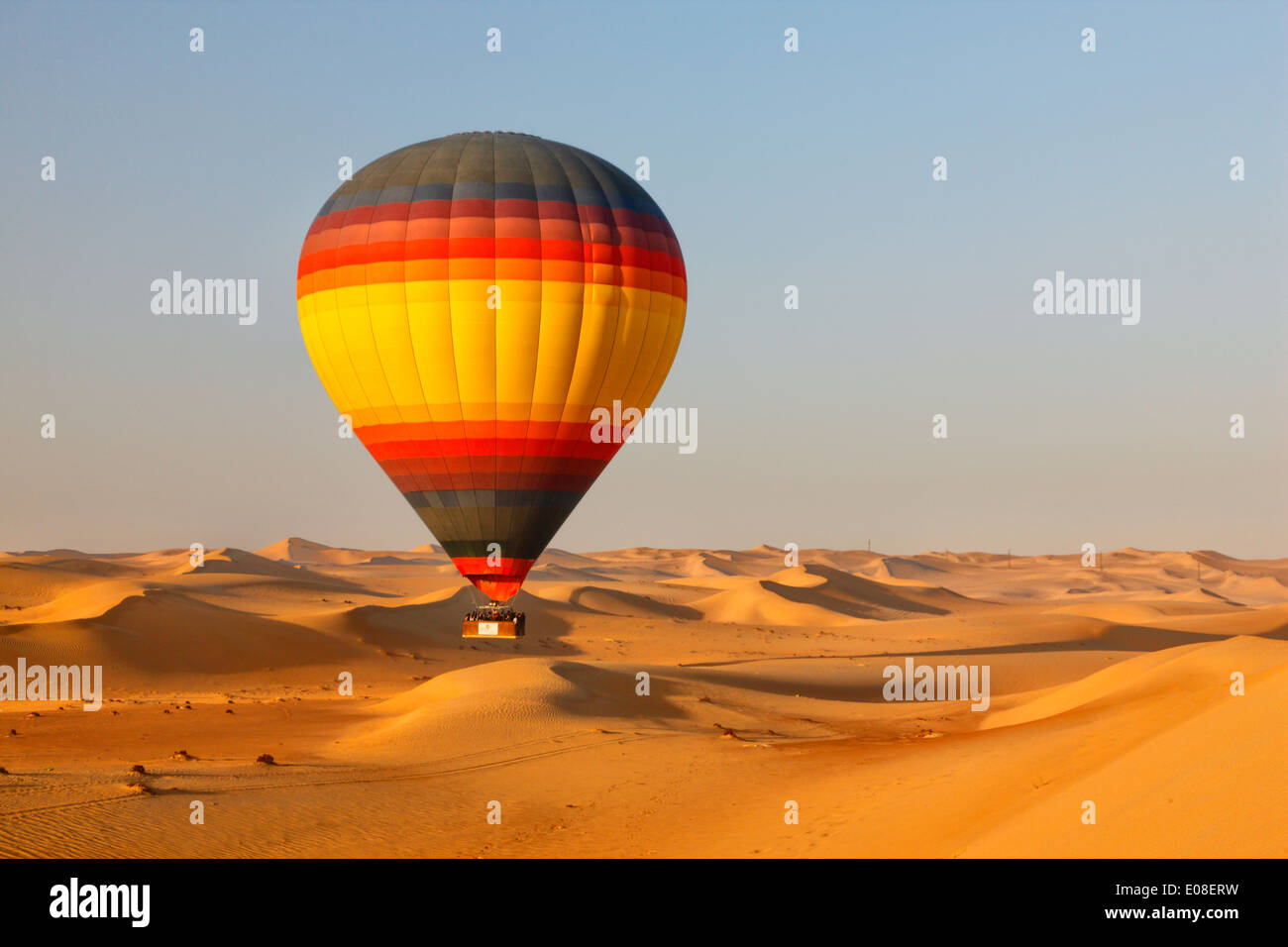 Fly over Dubai desert with hot air balloon Stock Photo