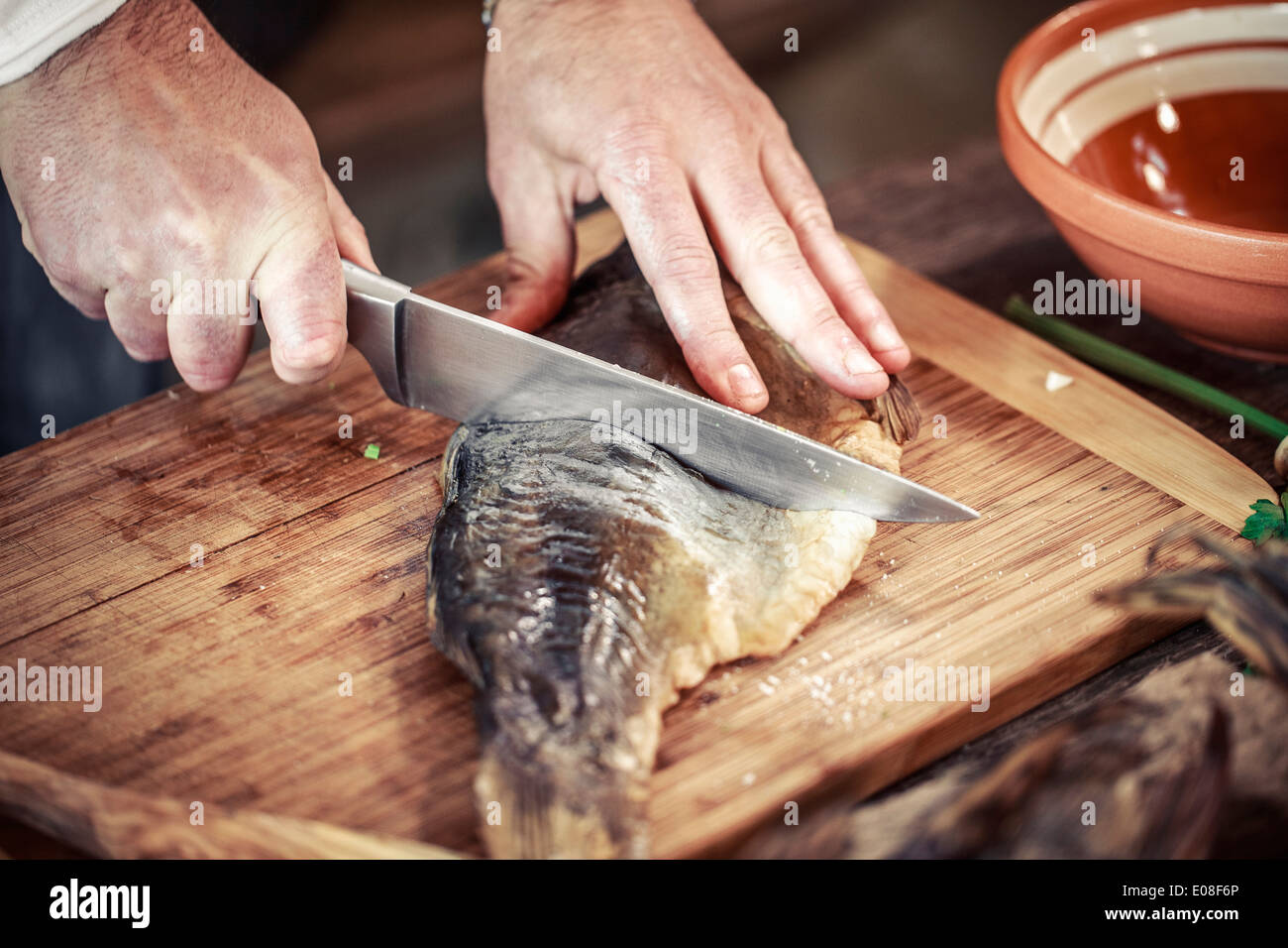 Unrecognizable person cutting pike fish Stock Photo