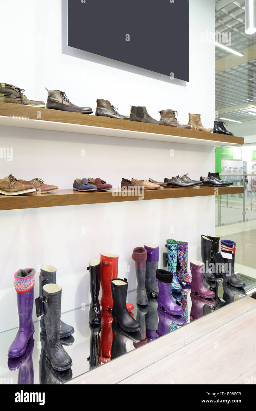 bright and fashionable interior of shoe store in modern mall Stock