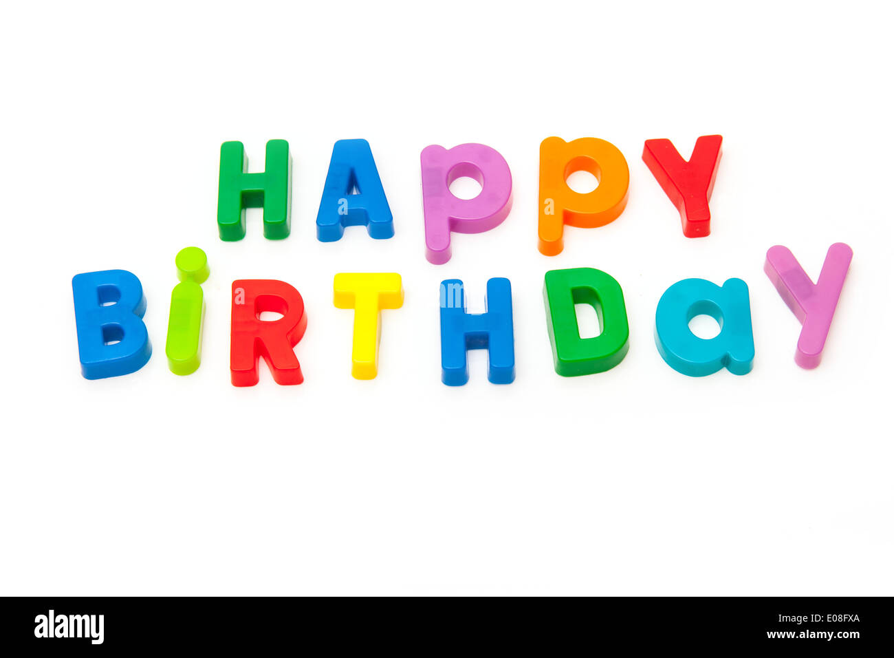 Happy Birthday written in magnetic letters isolated on a white studio background. Stock Photo