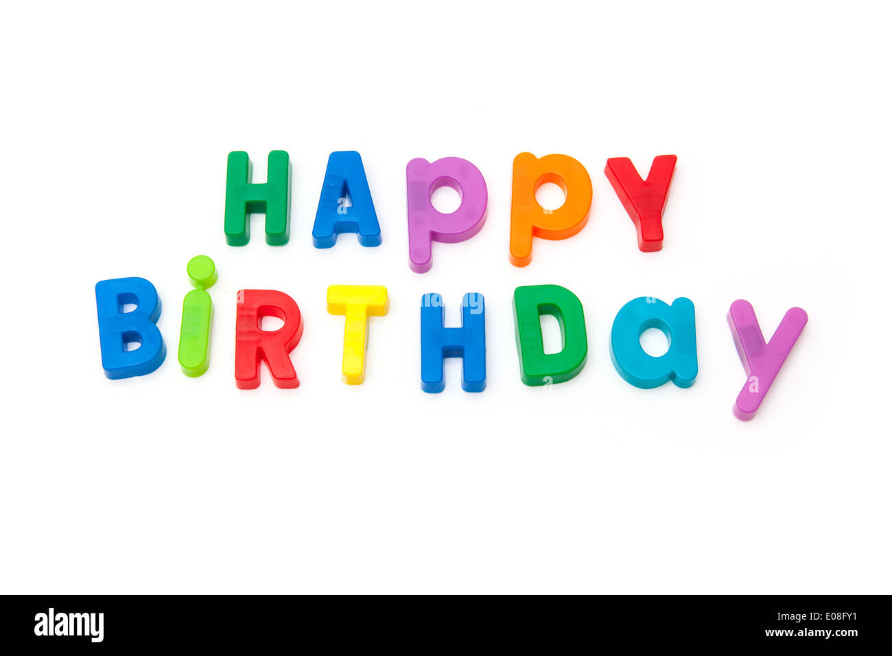 Happy Birthday written in magnetic letters isolated on a white studio background. Stock Photo