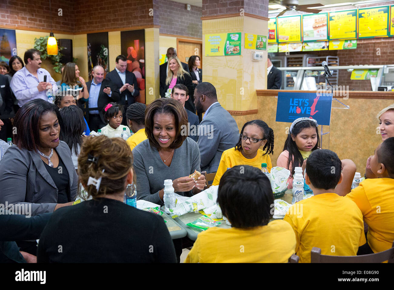 US First Lady Michelle Obama joins students and parents for lunch at a Subway restaurant to announce that Subway will work with Partnership for a Healthier America to help advance the goals of 'Let's Move!,' January 23, 2014 in Washington, DC. Stock Photo