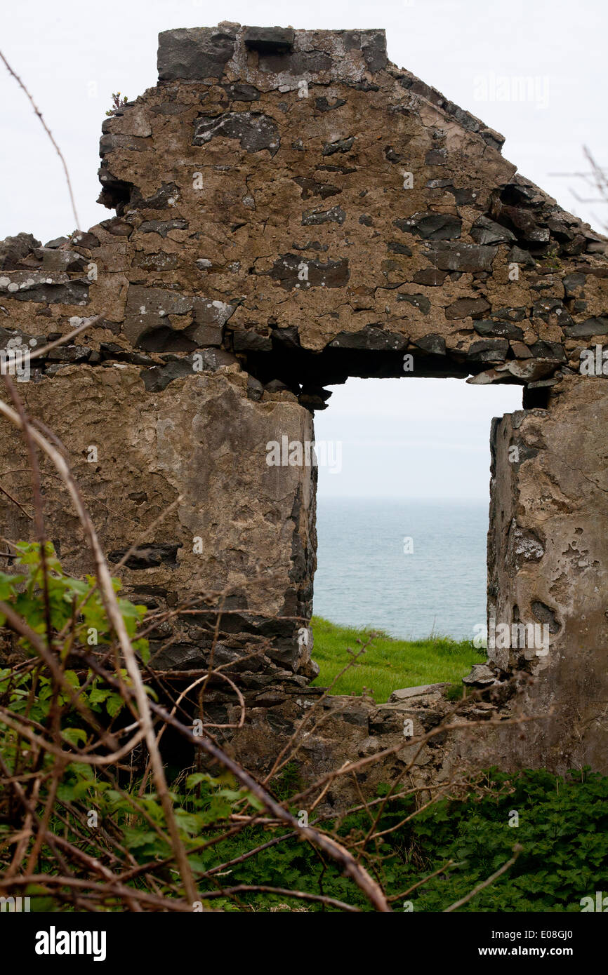 A view through a window of a derelict house / fomer miner's cottage above Porth Ysgo, Aberdaron Stock Photo
