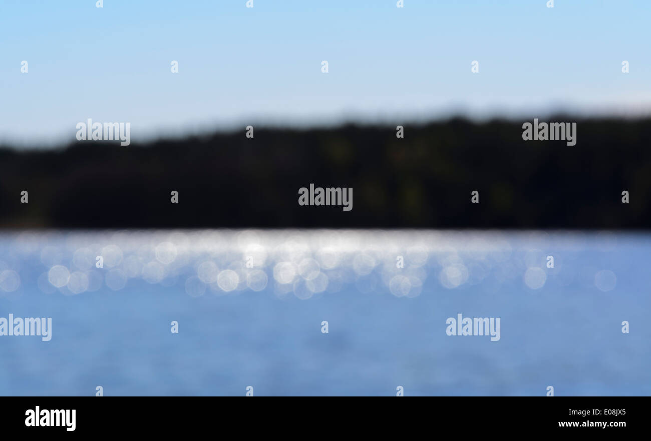 Sunshine on a lake and island blurry background, Lake Malaren, Stockholm, Sweden in May. Stock Photo