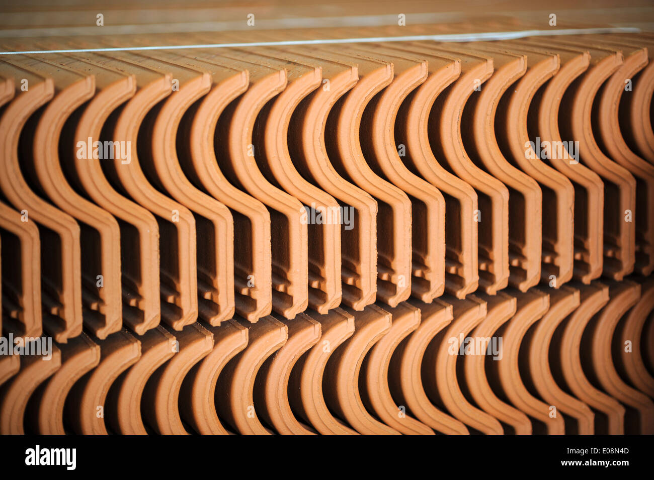 Clay roof tiles lined up in a factory Stock Photo