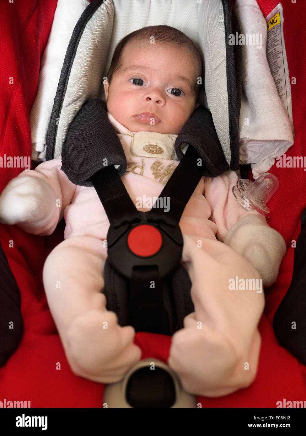 Baby strapped into a car seat Stock Photo