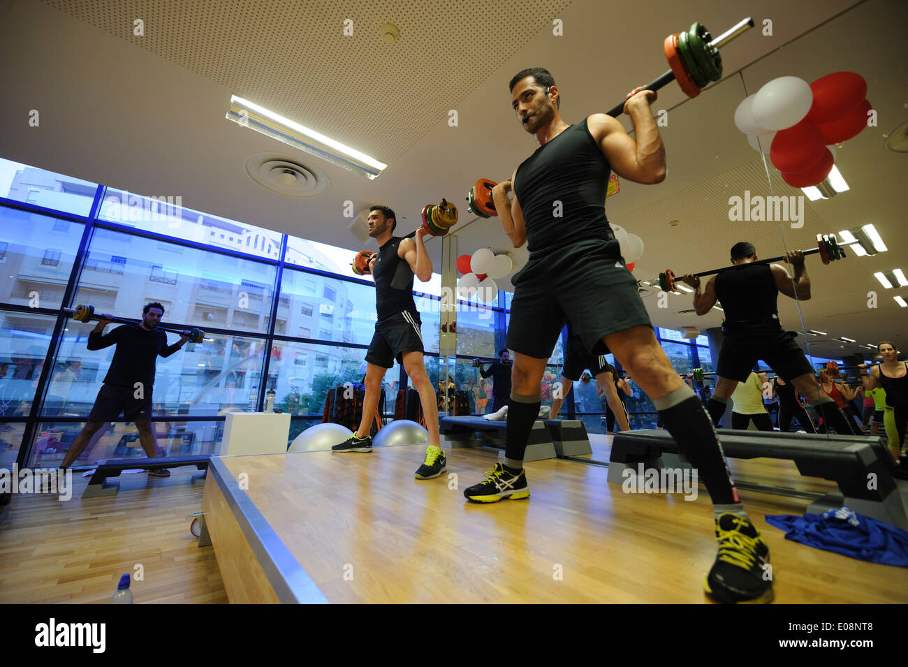 Fitness instructors doing squats during Body Pump fitness class at the