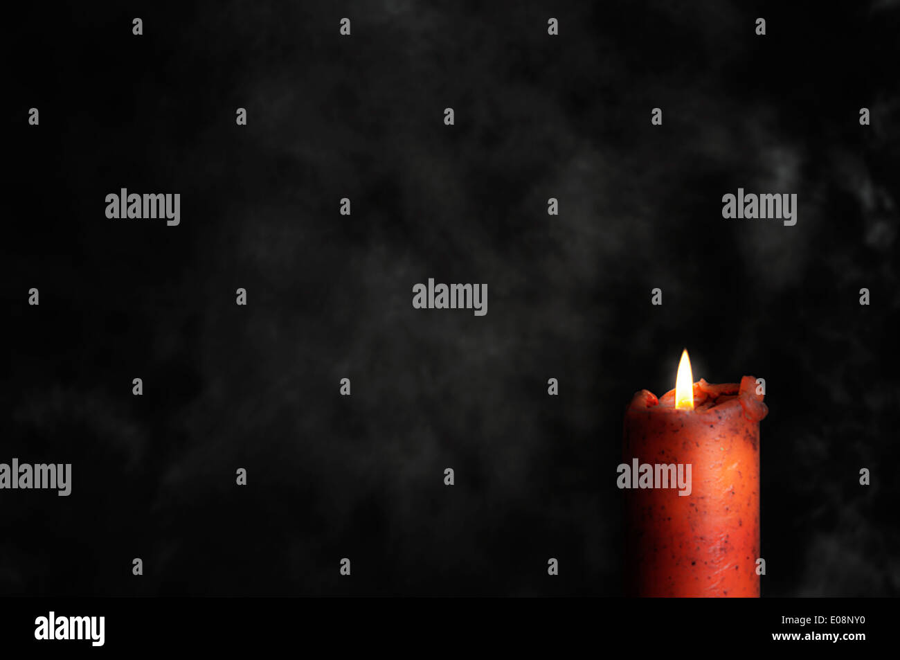 Burning red candle in the dark Stock Photo Alamy