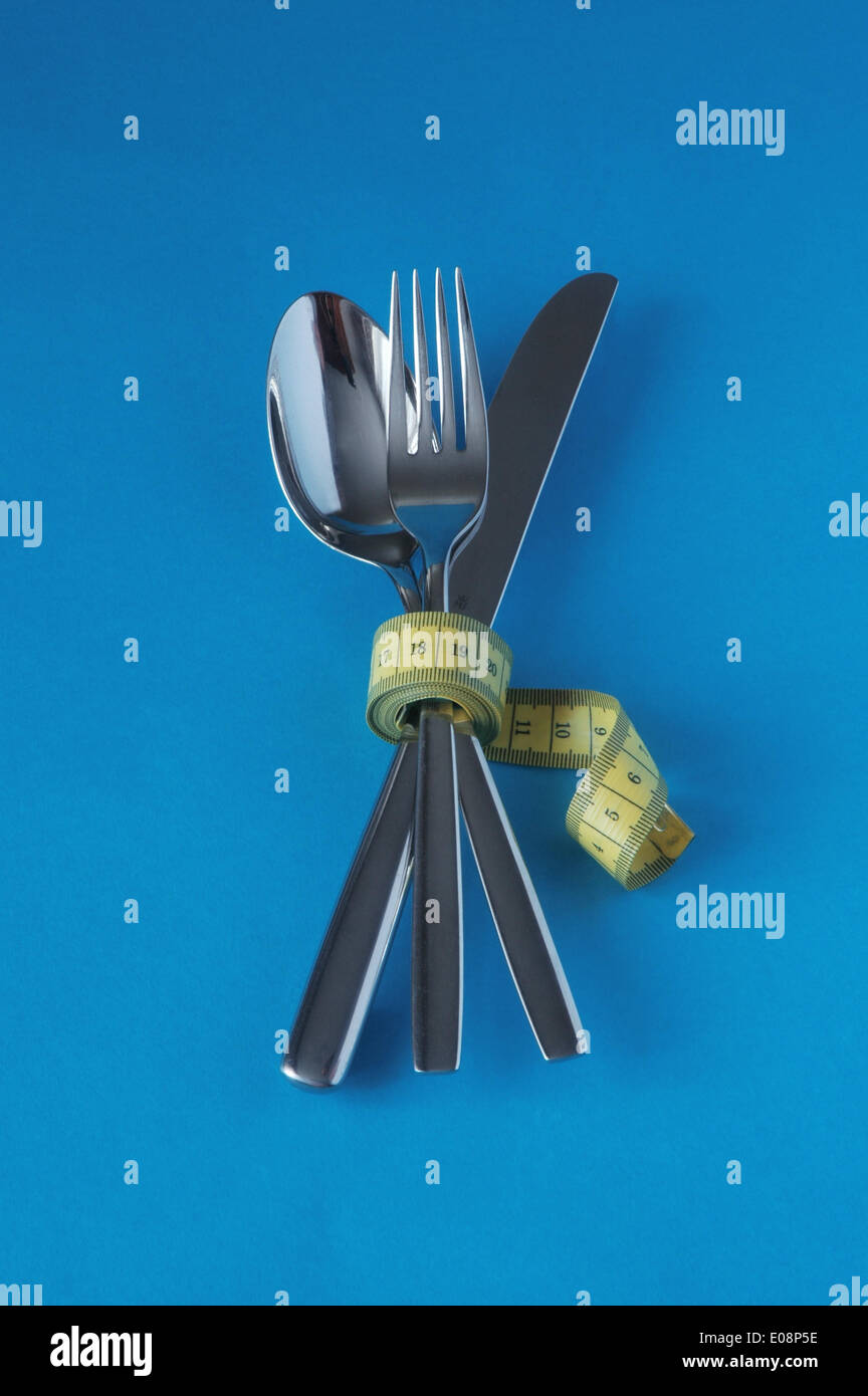 Illustration - Measuring tape is wrapped around cutlery in Germany, 10 February 2010. Fotoarchiv für Zeitgeschichte - NO WIRE SERVICE Stock Photo