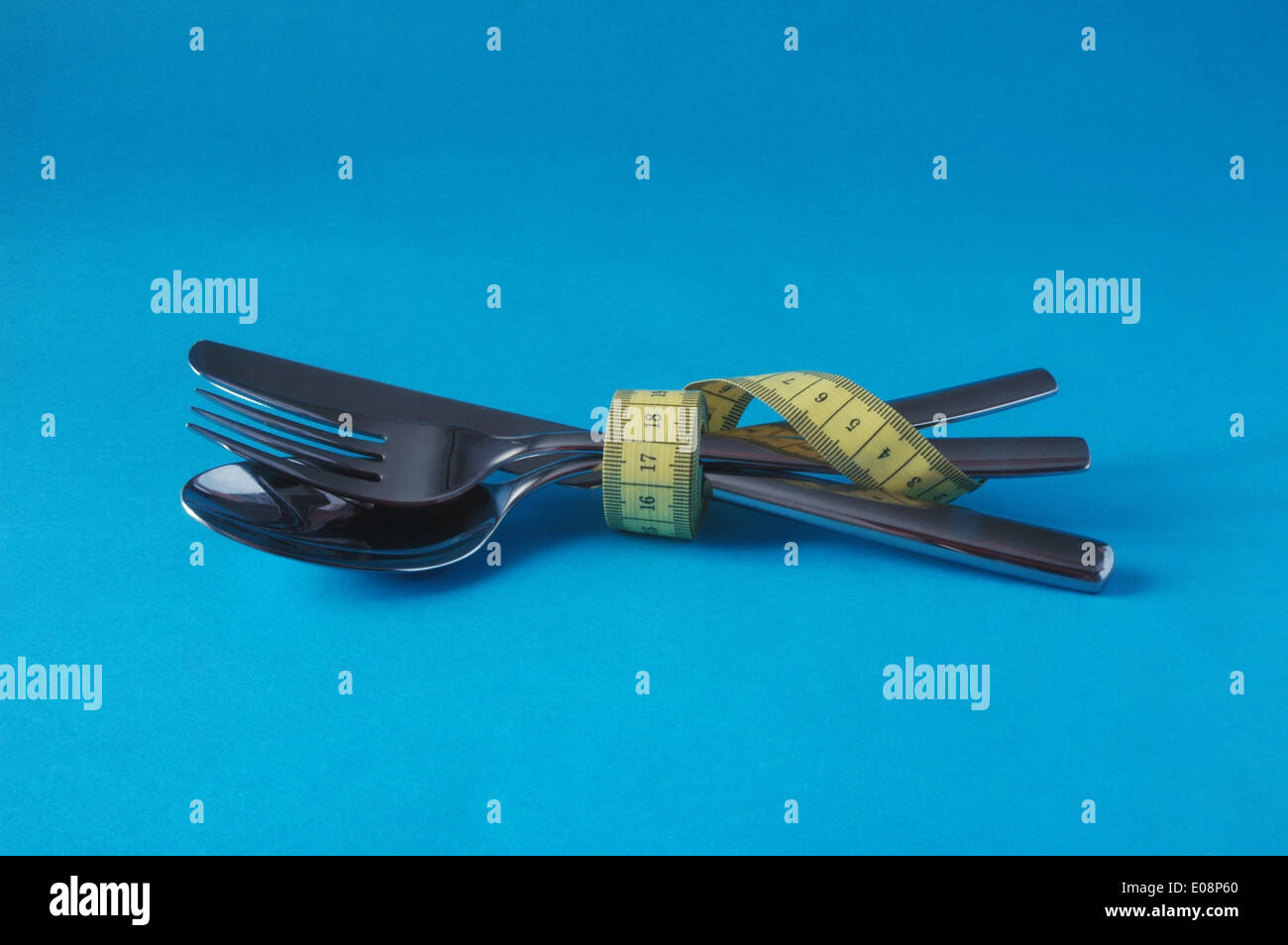 Illustration - Measuring tape is wrapped around cutlery in Germany, 10 February 2010. Fotoarchiv für Zeitgeschichte - NO WIRE SERVICE Stock Photo