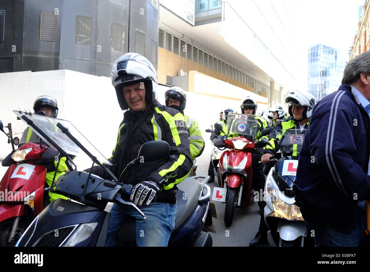 London, UK. 06th May, 2014. Black Cabbies held a demo near the Shard against TFL causing traffic chaos.  Riders doing the Knowledge join the protest Credit:  Rachel Megawhat/Alamy Live News Stock Photo