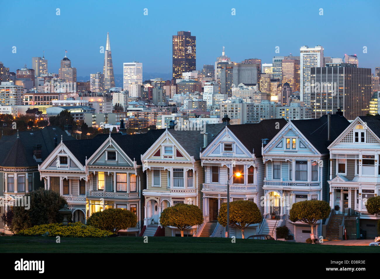 The Painted Ladies and the city at dusk, Alamo Square, San Francisco, California, United States of America, North America Stock Photo