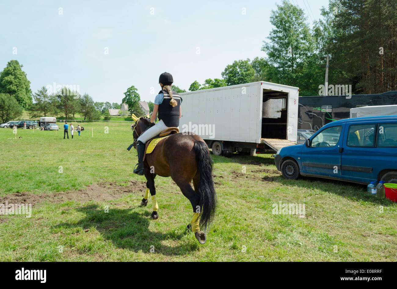Young girl with uniform ride dwarf horse before competition. Historic ...