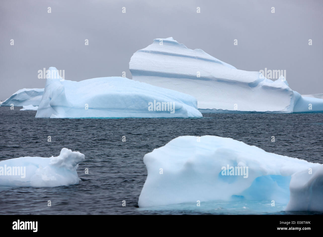 wind blown and shaped icebergs near cuverville island Antarctica Stock Photo