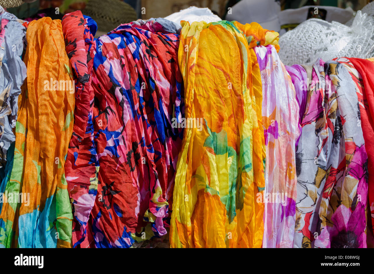 multicolor fashionable cloaks shawls and scarves sold in outdoor fair market. Stock Photo