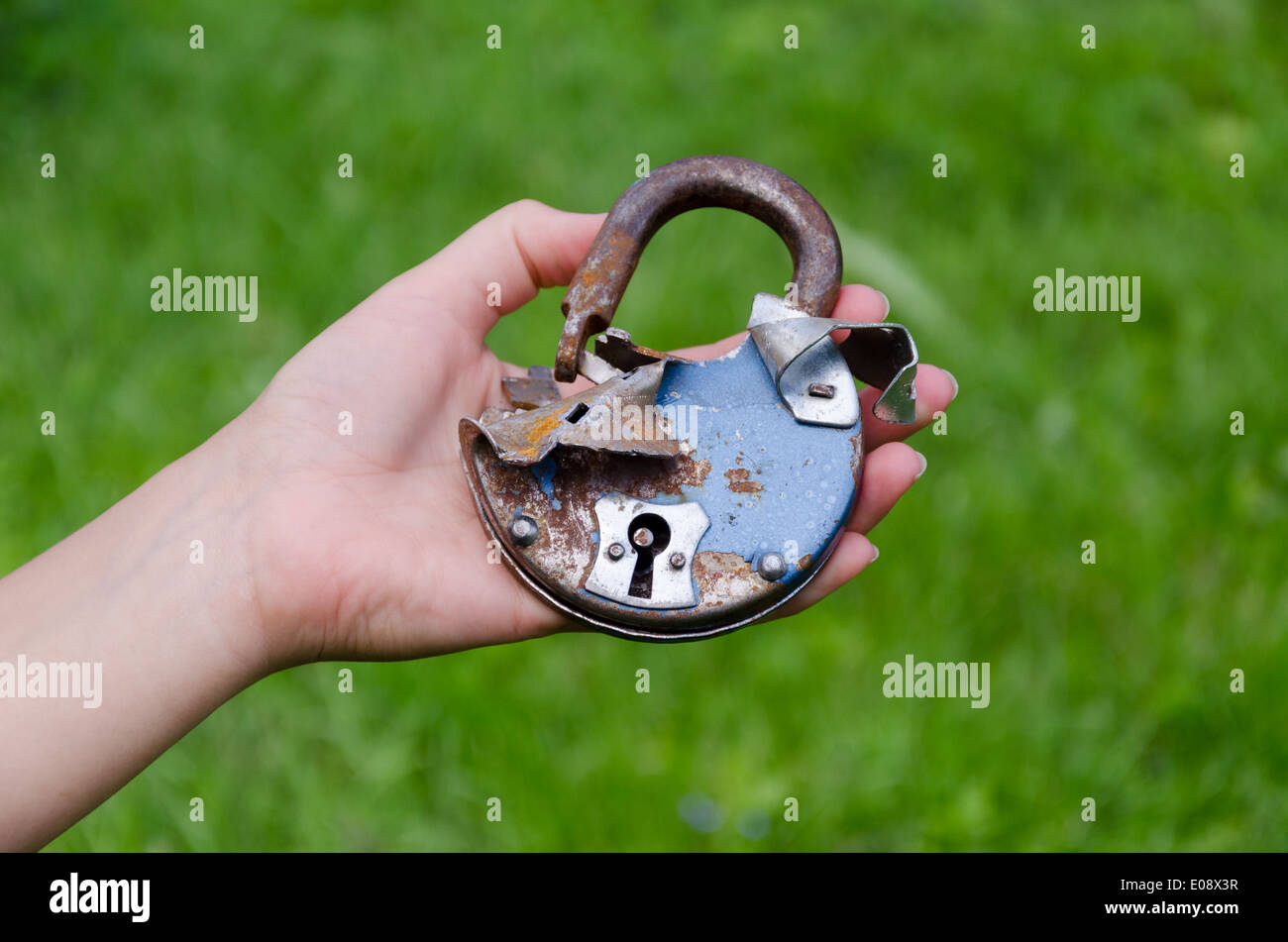 close up of old rusty broken door lock on man hand outdoor Stock Photo