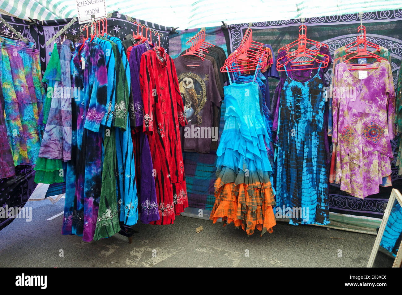 Colourful dresses for sale in Glastonbury Market, Somerset Stock Photo