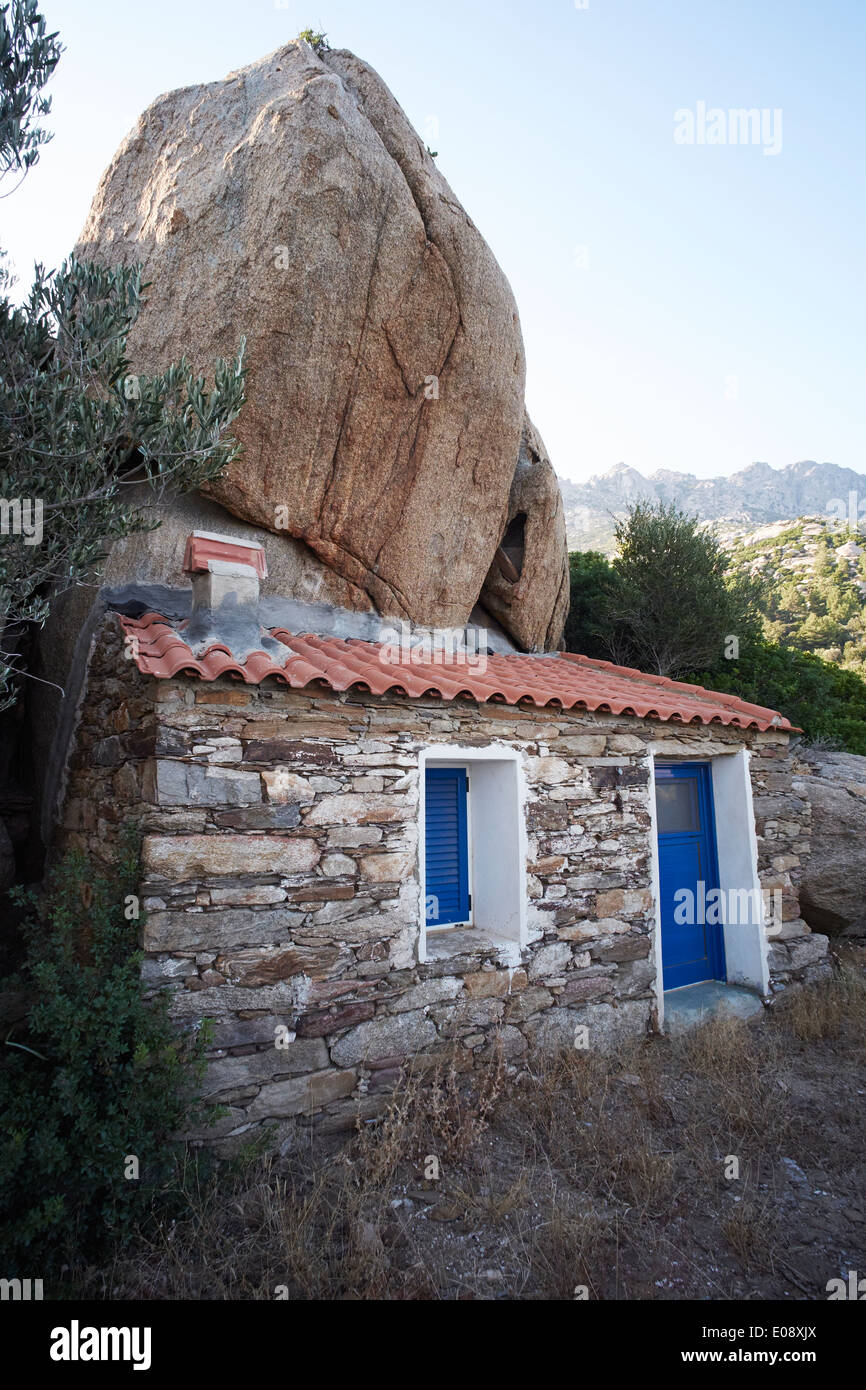 House built under volcanic rock, Ikaria, Greece Stock Photo