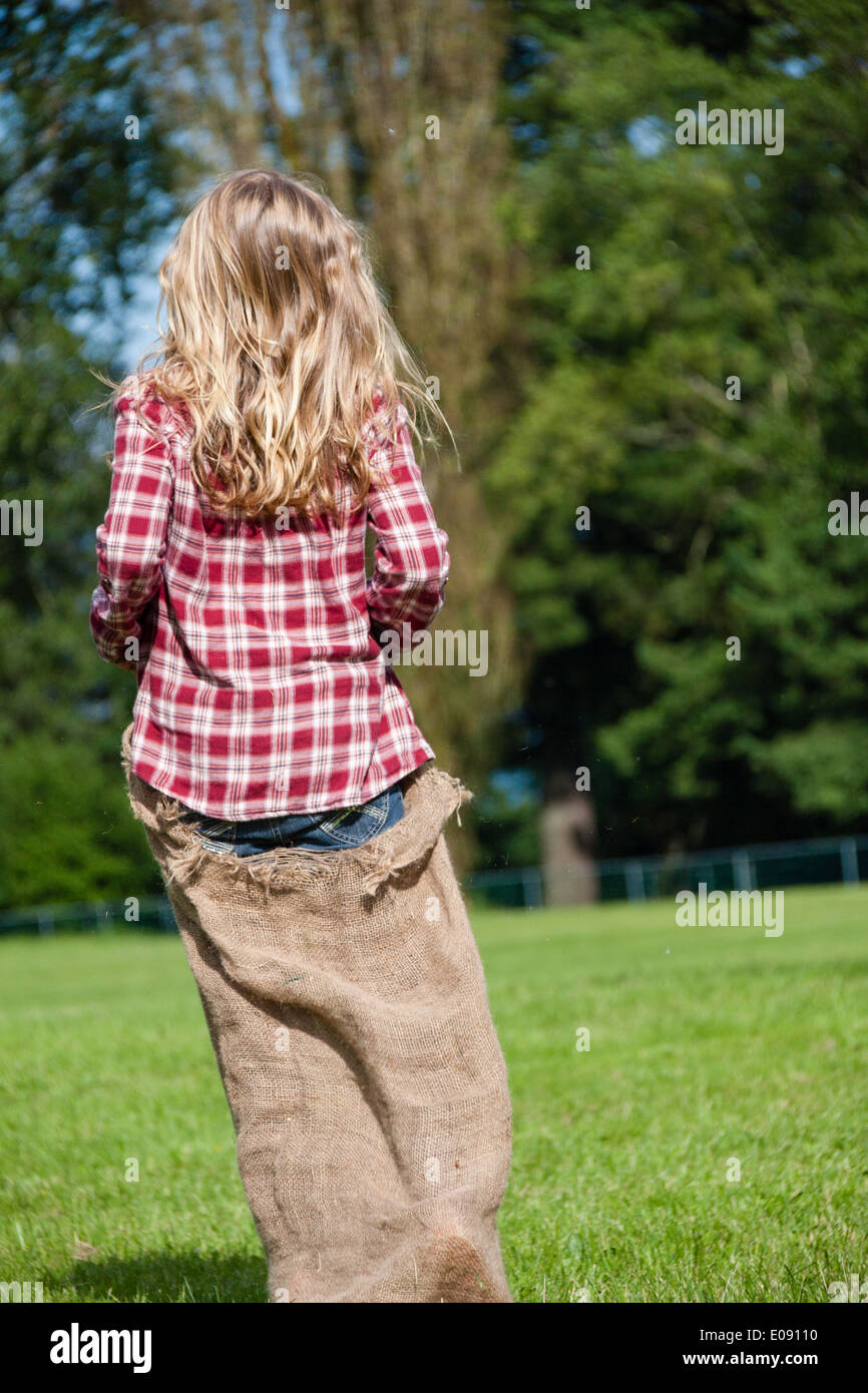 Girl in a gunny sack race Stock Photo Alamy