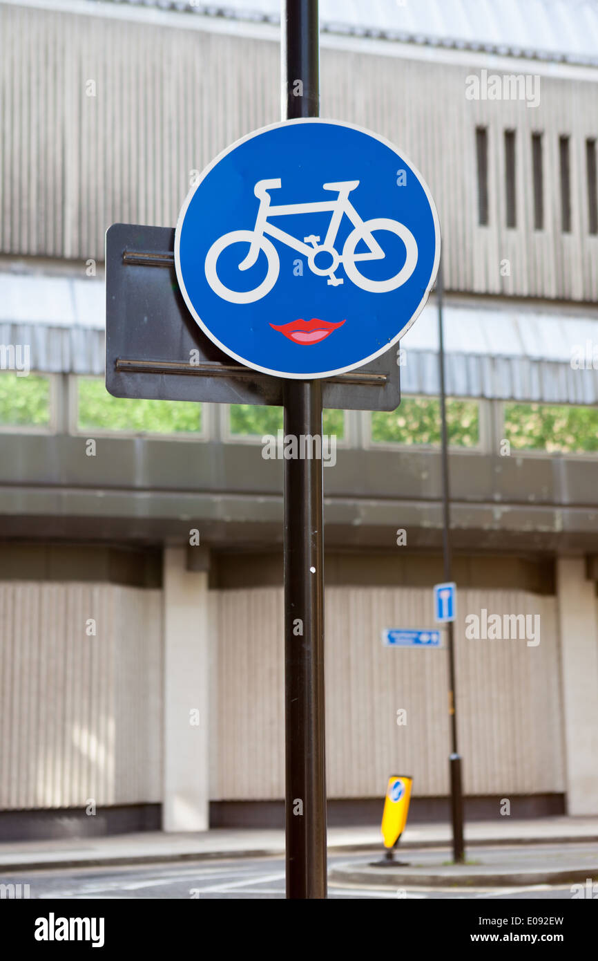Clet Abraham puts stickers on street signs to alter their meaning. Stock Photo