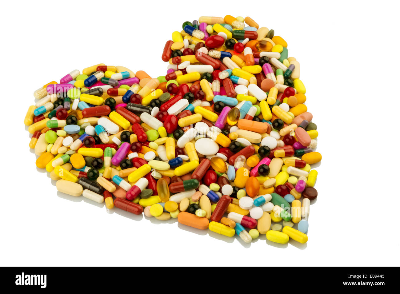 Coloured tablets in heart form arranged, symbolic photo fue heart deseases, medication and Pharmazeutika, Bunte Tabletten in Her Stock Photo