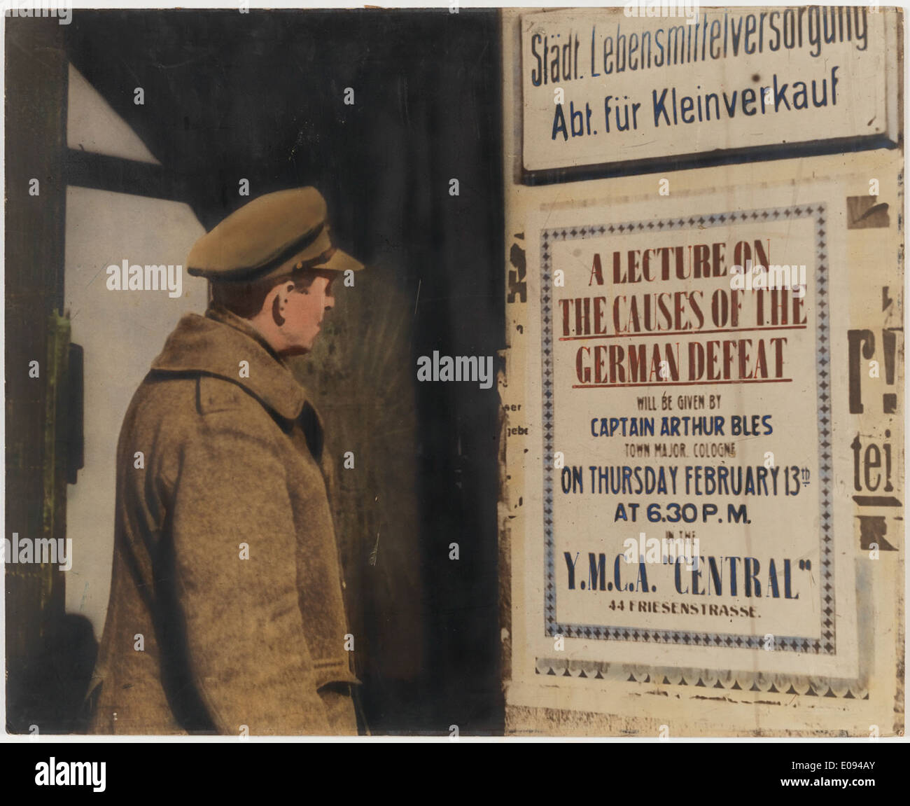 Soldier looking at billboard: “Lecture on causes of German defeat..' Stock Photo