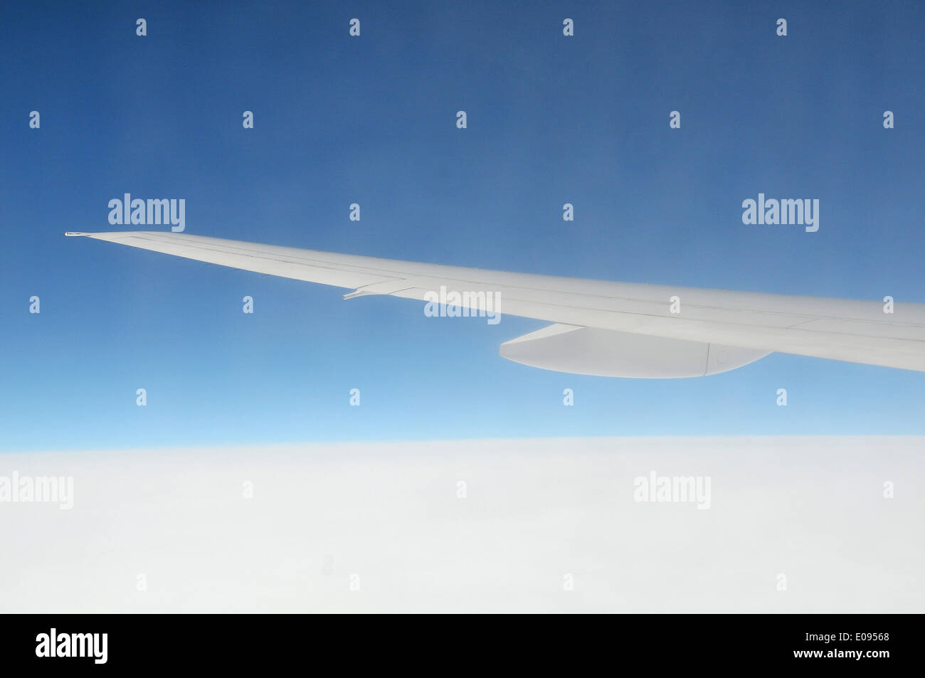 Airplane wing above cloud in blue sky Stock Photo - Alamy