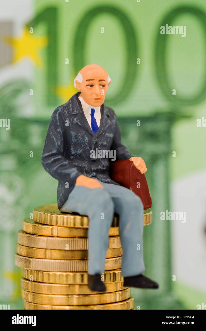 Pensioner sits on monetary pile, symbolic photo fue pension, old-age provisions, provision for the old age, Rentner sitzt auf Ge Stock Photo