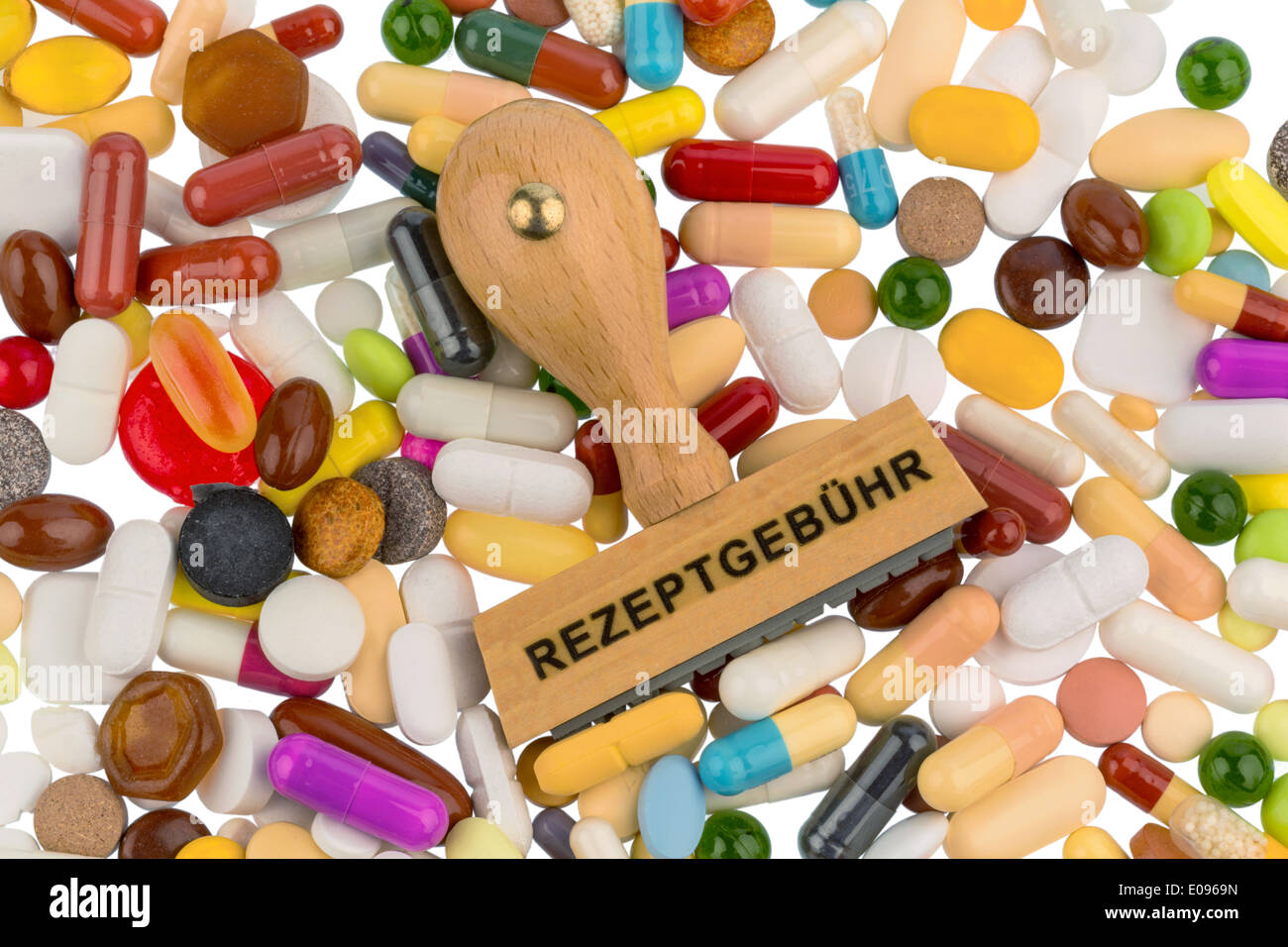 Stamp on coloured tablets, symbolic photo fue drugs, recipe duty and additional payment, Stempel auf Bunten Tabletten, Symbolfot Stock Photo