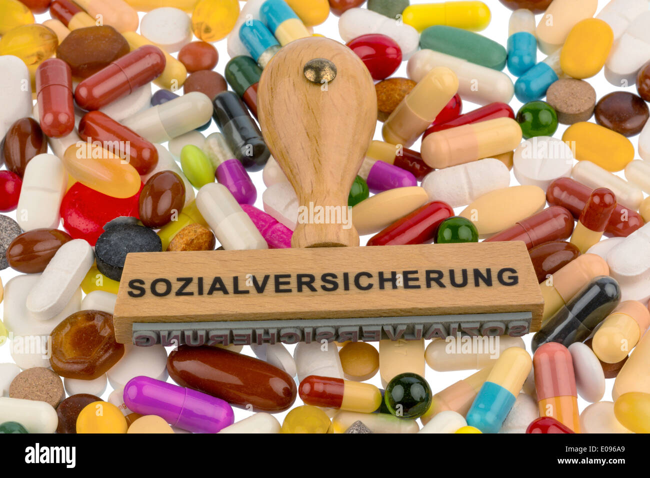 Stamp on coloured tablets, Symbolfot fue social security, drugs and cost allowance, Stempel auf bunten Tabletten, Symbolfot fue Stock Photo