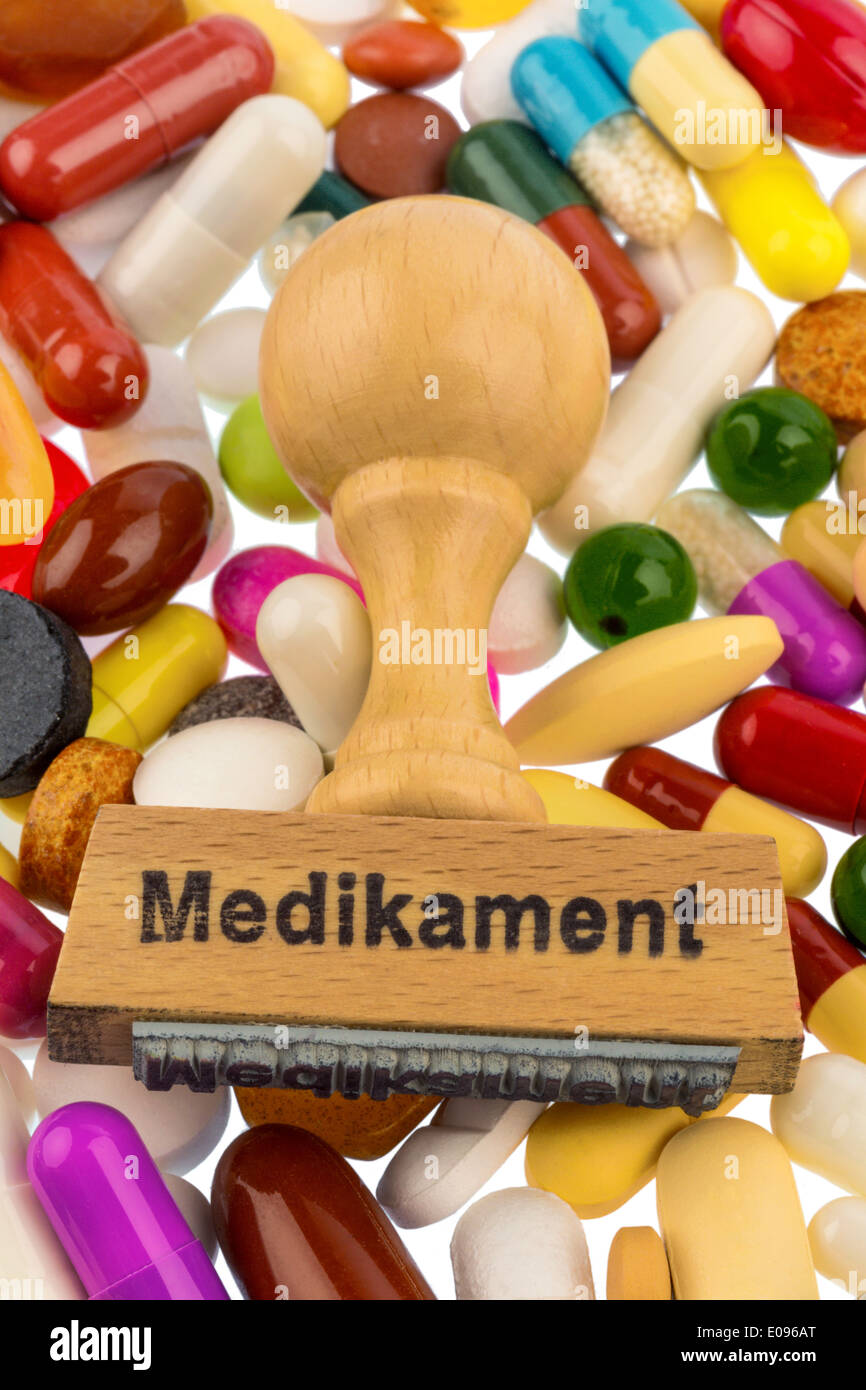 Stamp on coloured tablets, symbolic photo fue Medikamentoese therapy and Verschreibungspflicht, Stempel auf bunten Tabletten, Sy Stock Photo