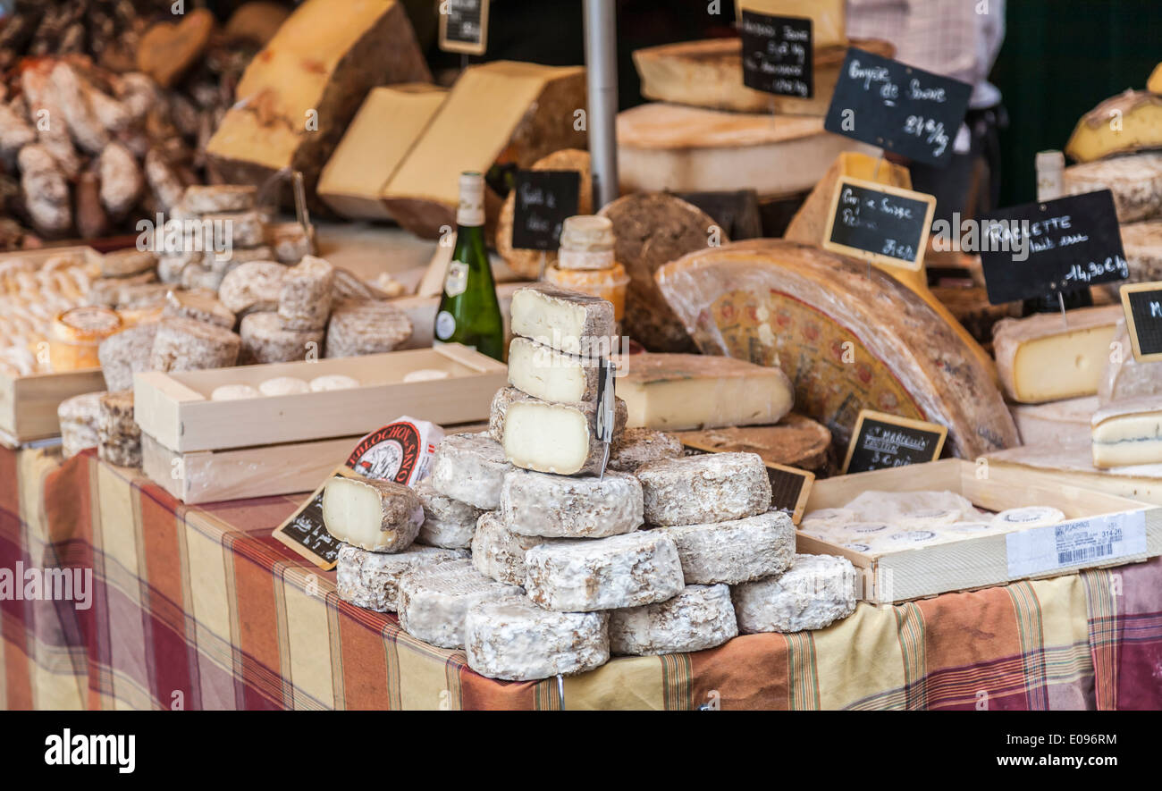 Cheese stall in market in Annecy, France with a wide selection of hard