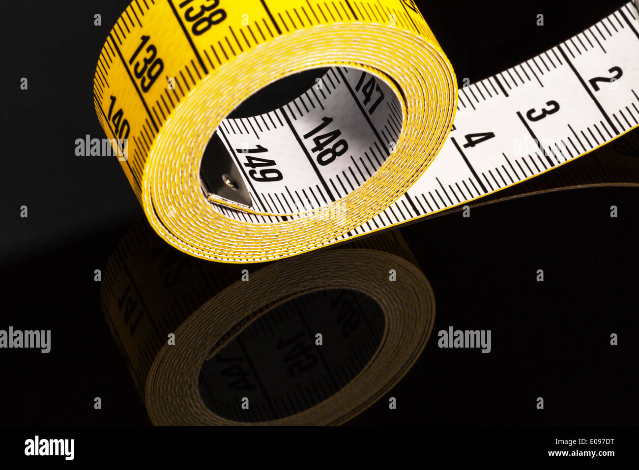 Yellow dimension tape, symbolic photo for diet, control and precision Stock Photo