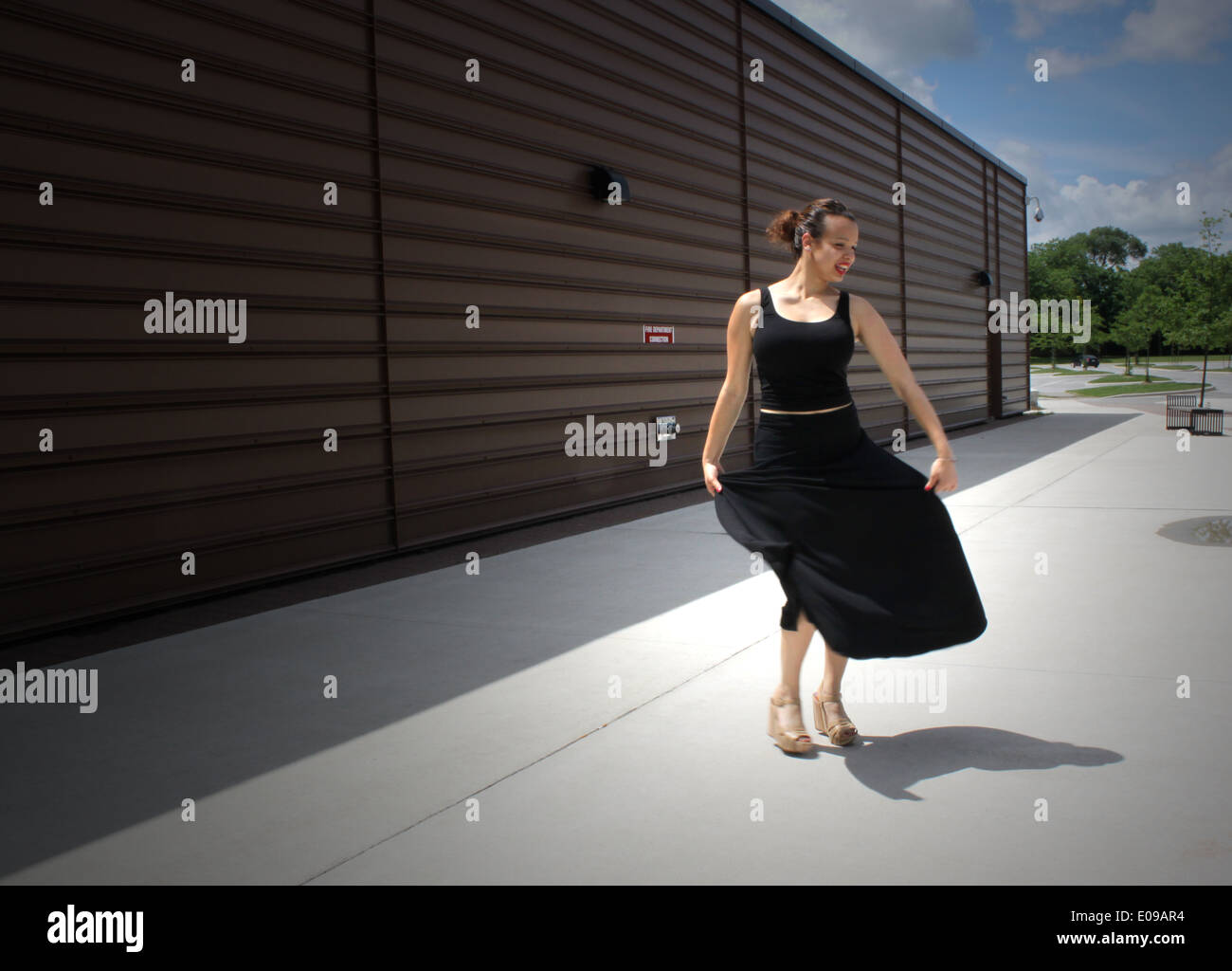 Girl in a black dress dances flamenco on the street in Toronto, Canada Stock Photo
