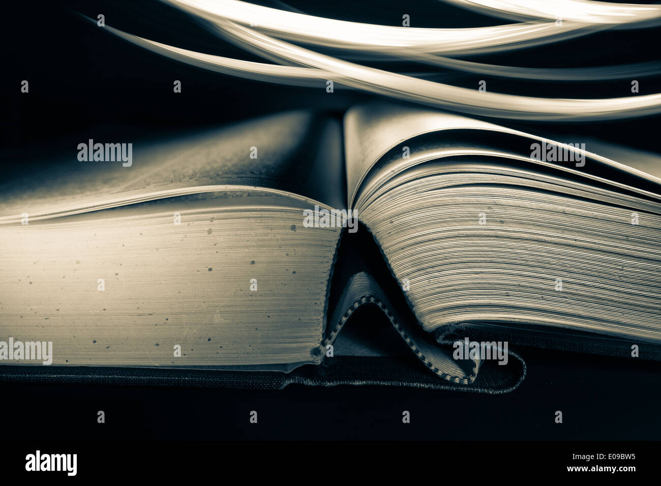 Open hardcover book with light effects Stock Photo