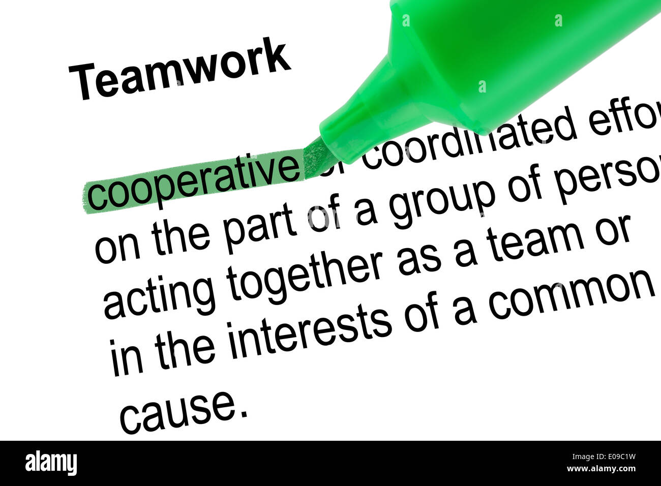 Highlighted word cooperative for Teamwork with green pen over white paper. Isolated white background. Stock Photo