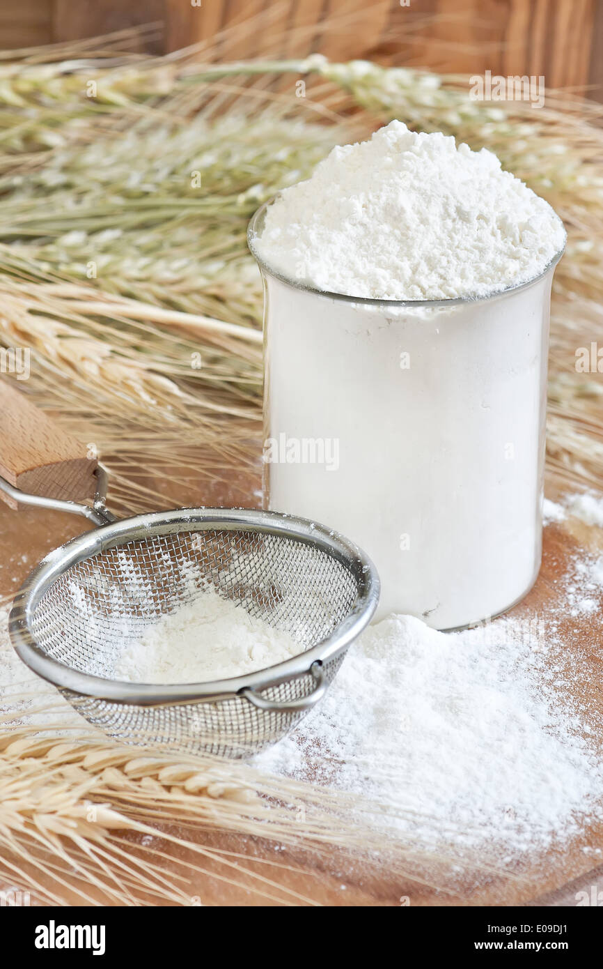 Wheat flour in glass, sifter and grains. Selective focus Stock Photo Alamy