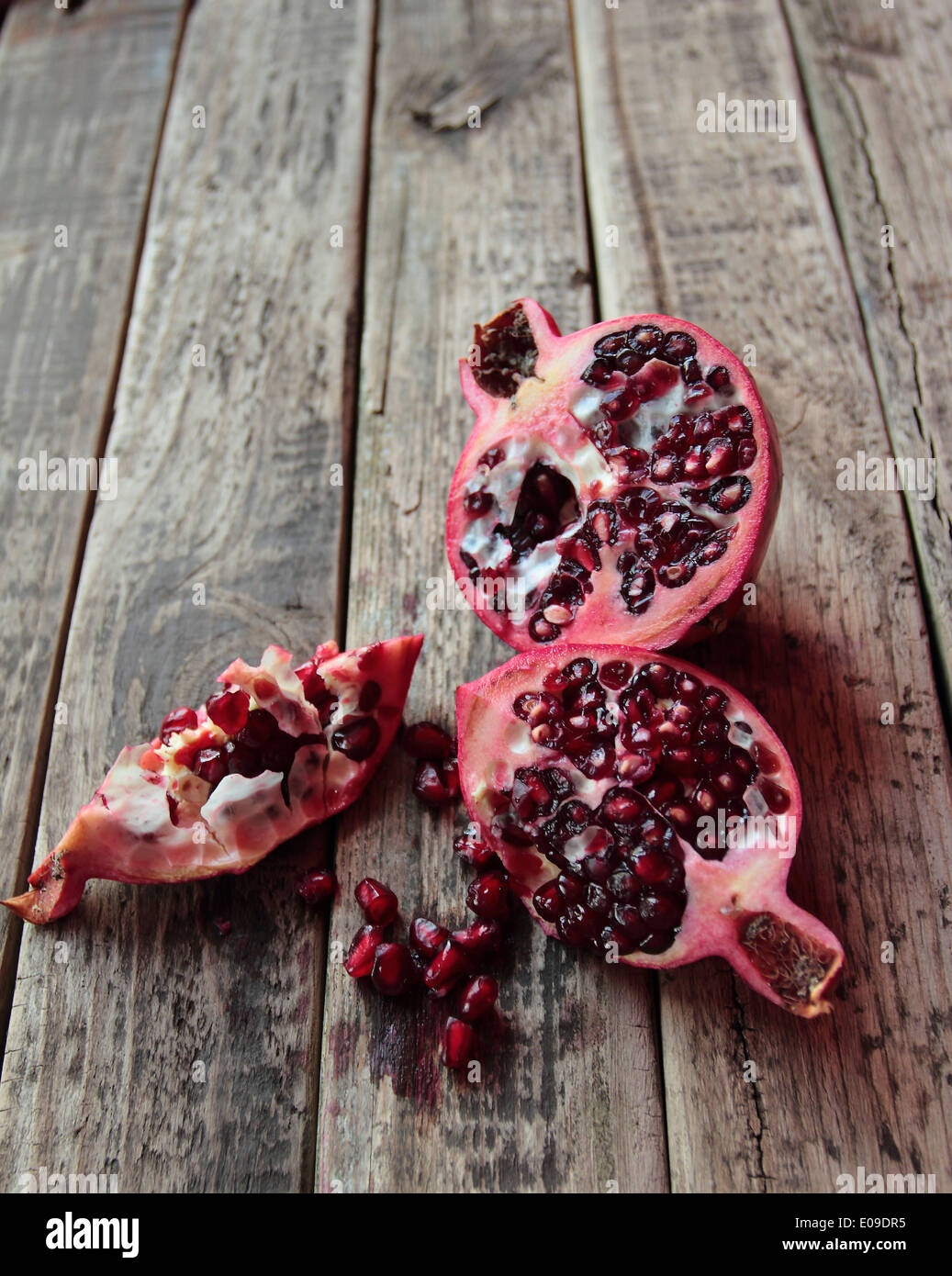 Ripe pomegranate fruit on the wooden table Stock Photo