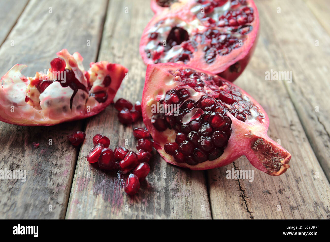 Fresh pomgranate on wooden kitchen table Stock Photo