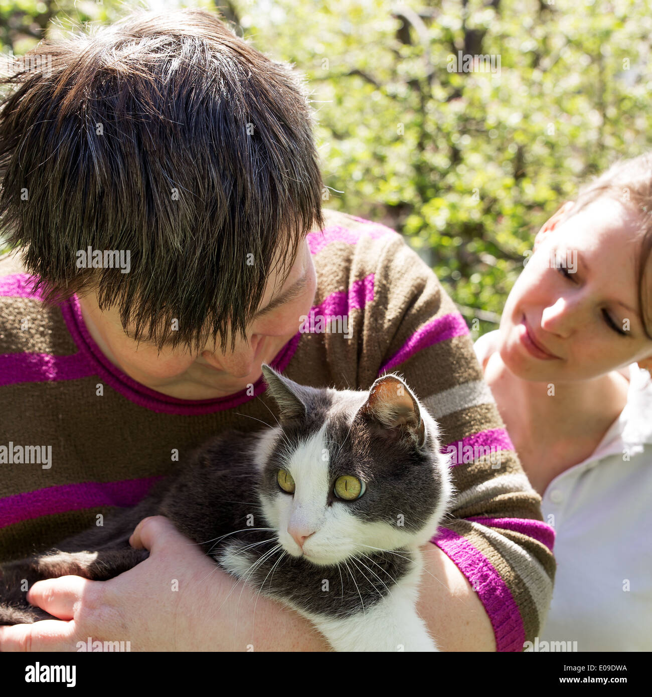 disabled woman cuddles a cute cat Stock Photo