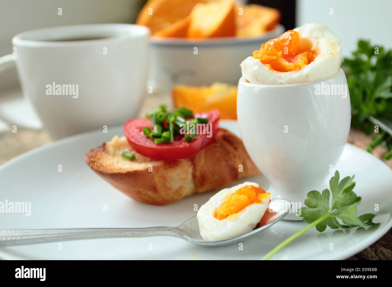 Boiled egg with crunchy bread and fresh vegetables Stock Photo
