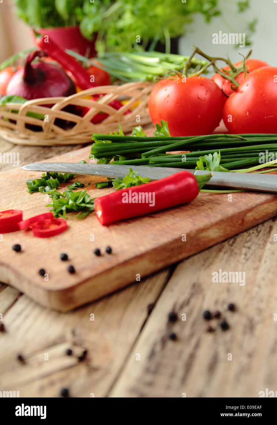 Fresh ripe raw vegetables on wooden cutting board Stock Photo by ratmaner