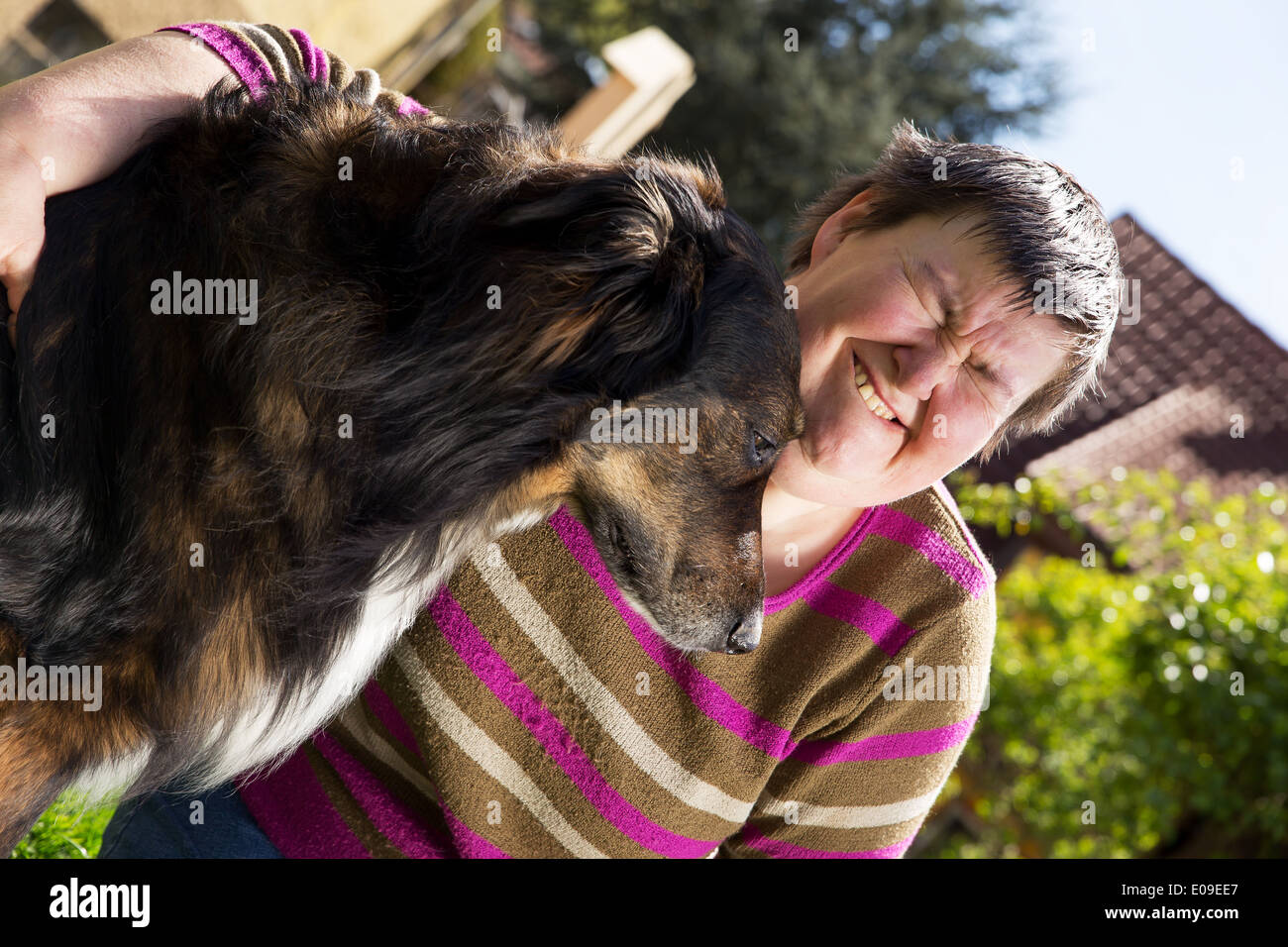 disabled woman sitting outdoors with an half breed dog Stock Photo