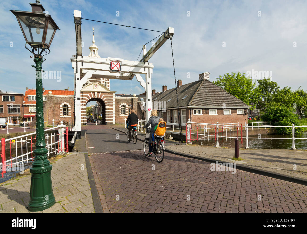 CYCLISTS CROSSING THE MORSPOORT BRIDGE IN LEIDEN HOLLAND Stock Photo