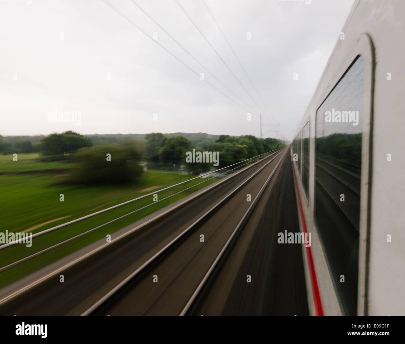 Germany, fast moving train in landscape Stock Photo