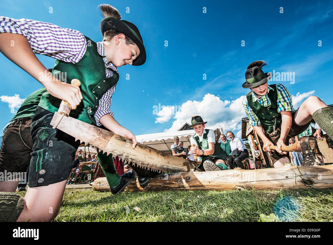 Austria, Idning, Boys in traditional clothing preparing the may pole Stock Photo