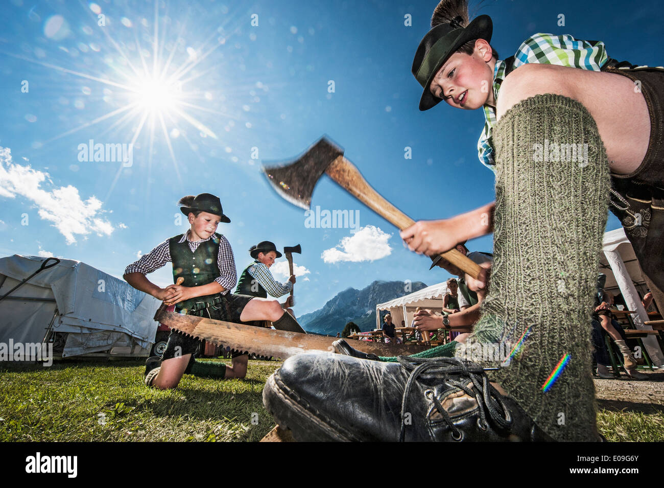 Austria, Idning, Boys in traditional clothing preparing the may pole Stock Photo