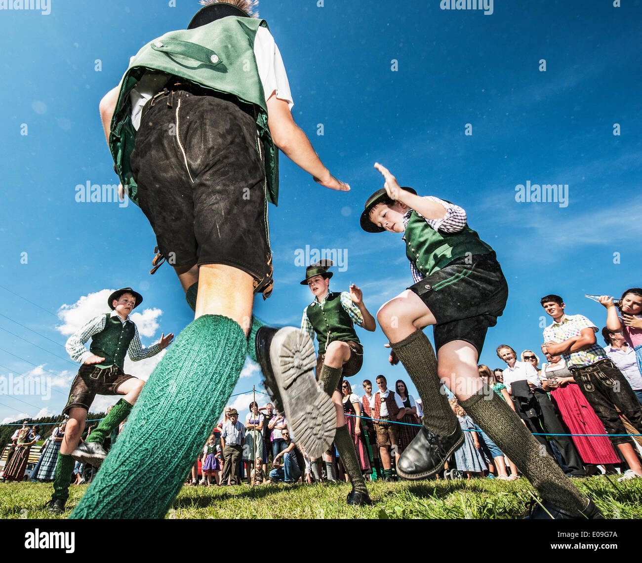 Austria, Irdning, Boys in traditional clothing dancing the Schuhplattler at May festival Stock Photo