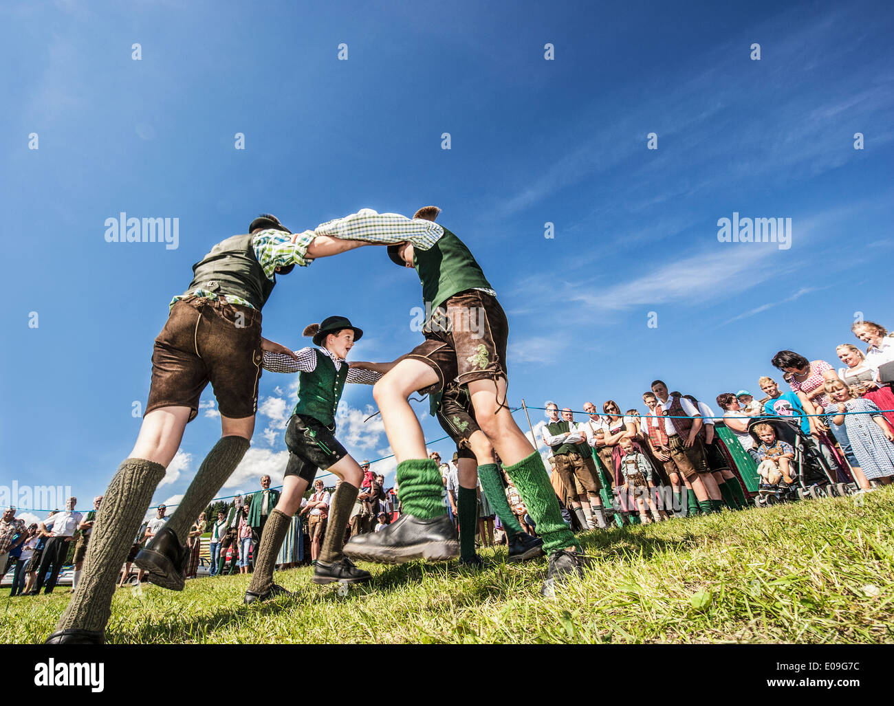 Austria, Irdning, Boys in traditional clothing dancing the Schuhplattler at May festival Stock Photo